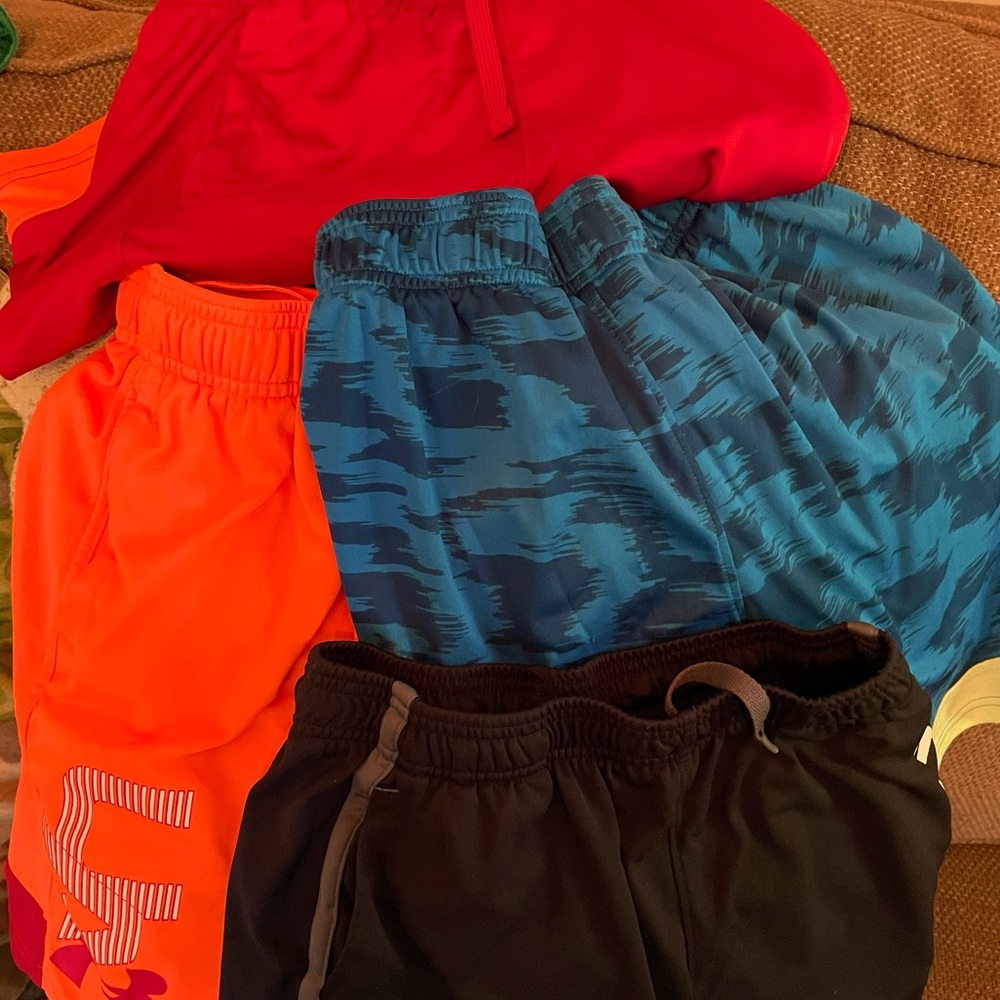 Four (4) pair of Under Armour Boys athletic shorts, size youth medium. GUC.